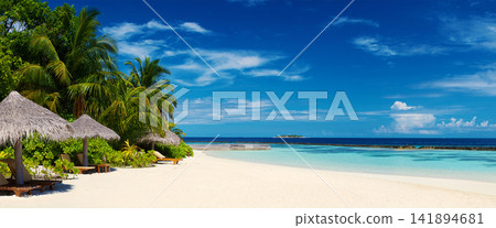 Tropical Beach Resort with Palm Trees and Turquoise Lagoon Tropical Beach Resort with Palm Trees and Turquoise Lagoon 141894681