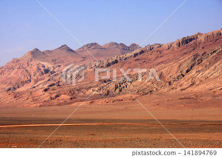 Red Desert Mountain Landscape Under Clear Blue Sky Red Desert Mountain Landscape Under Clear Blue Sky 141894769