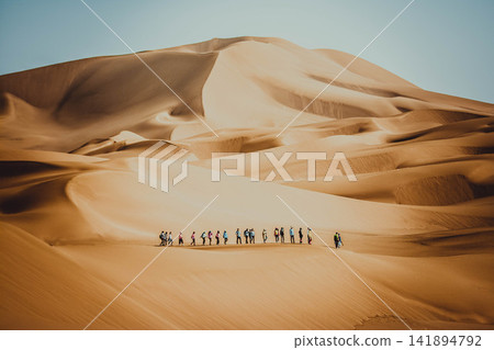Desert Sand Dunes with Hiking Group in Vast Golden Landscape 141894792