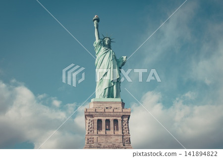 Statue of Liberty Landmark Against Cloudy Blue Sky Statue of Liberty Landmark Against Cloudy Blue Sky 141894822