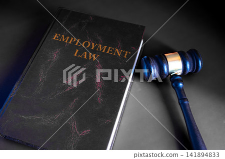 Judge wooden gavel on Employment Law dark book on gray background, labor law and court justice concept Judge wooden gavel on Employment Law dark book on gray background, labor law and court justice concept 141894833