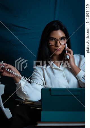 Businesswoman multitasking with phone calls and technology Businesswoman multitasking with phone calls and technology 141895419