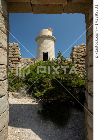 Abandoned Lighthouse Ruins with Distant Tower Against Blue Sky Abandoned Lighthouse Ruins with Distant Tower Against Blue Sky 141895531