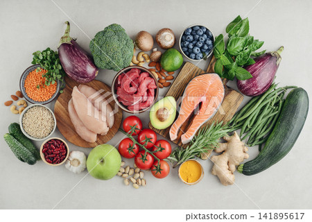 Top view of raw whole foods for Mediterranean diet, clean eating and nutritious meal planning. Top view of raw whole foods for Mediterranean diet, clean eating and nutritious meal planning. 141895617