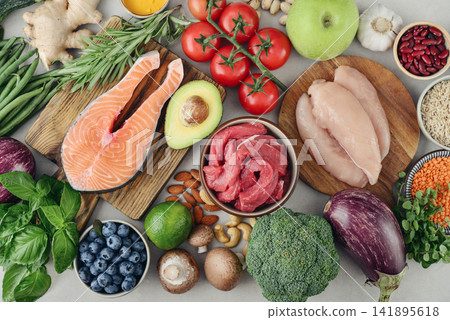 Top view of raw whole foods for Mediterranean diet, clean eating and nutritious meal planning. Top view of raw whole foods for Mediterranean diet, clean eating and nutritious meal planning. 141895618