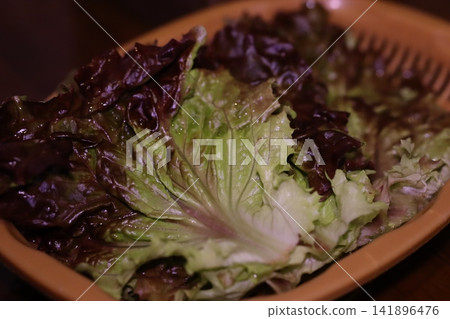 Fresh Mixed Leafy Greens in Terracotta Bowl Fresh Mixed Leafy Greens in Terracotta Bowl 141896476