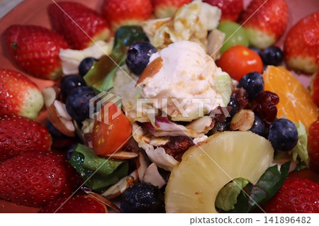 Vibrant Fruit Salad with Creamy Topping and Berries Vibrant Fruit Salad with Creamy Topping and Berries 141896482