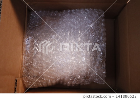 Cardboard Box with Bubble Wrap Packaging Cardboard Box with Bubble Wrap Packaging 141896522