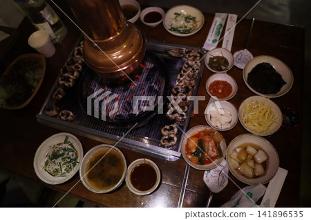 Korean BBQ Table with Grill and Side Dishes Korean BBQ Table with Grill and Side Dishes 141896535