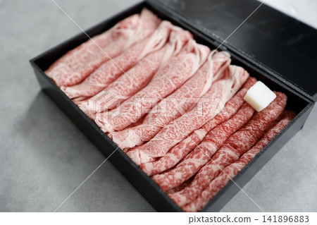 Wagyu beef for sukiyaki. Premium marbled beef beautifully arranged in a black box. Wagyu beef for sukiyaki. Premium marbled beef beautifully arranged in a black box. 141896883