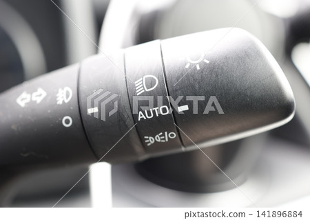 Automatic headlights in a car. AUTO function setting on the light switch. Headlight control. Automatic headlights in a car. AUTO function setting on the light switch. Headlight control. 141896884