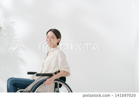 A smiling wheelchair user in her 40s A smiling wheelchair user in her 40s 141897020