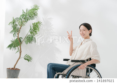 A smiling wheelchair user in her 40s A smiling wheelchair user in her 40s 141897021