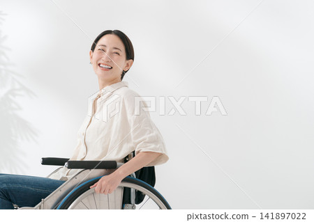 A smiling wheelchair user in her 40s A smiling wheelchair user in her 40s 141897022