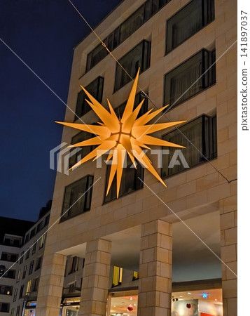 A large, glowing Christmas star on the building's facade. A large, glowing Christmas star on the building's facade. 141897037