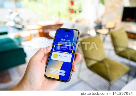 Operating a hotel app on a smartphone Operating a hotel app on a smartphone 141897054