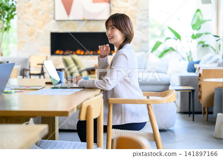 A woman working on her laptop. A woman working on her laptop. 141897166