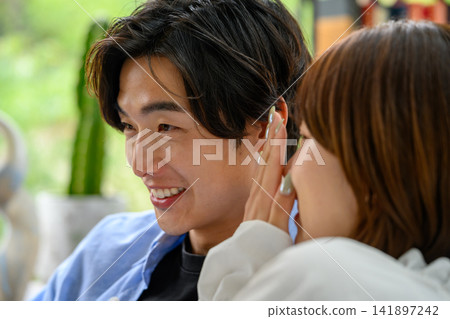 An intimate moment when a man whispers to a woman. An intimate moment when a man whispers to a woman. 141897242