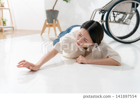 A woman who fell out of her wheelchair A woman who fell out of her wheelchair 141897554
