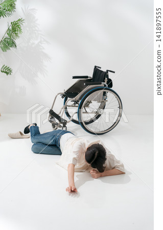 A woman who fell out of her wheelchair A woman who fell out of her wheelchair 141897555