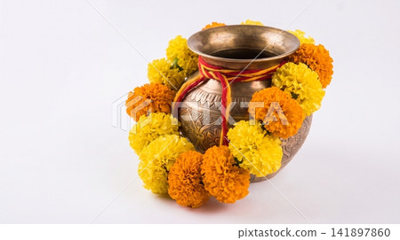 Traditional brass kalash pot decorated with marigold flower garland marigold traditional festival cultural ceremonial auspicious celebration offering blessing tradition religious botanical Traditional brass kalash pot decorated with marigold flower garland marigold traditional festival cultural ceremonial auspicious celebration offering blessing tradition religious botanical 141897860