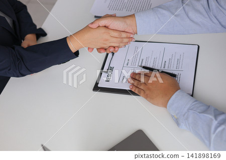 Human Resources Manager Shaking Hands with Candidate for New Job Recruitment. 141898169