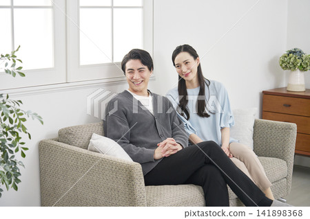 Portrait of a middle-aged couple in their living room. Portrait of a middle-aged couple in their living room. 141898368