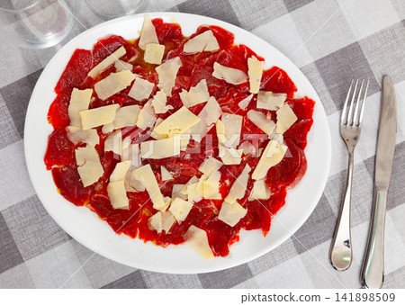 Carpaccio and cheese served on plate Carpaccio and cheese served on plate 141898509