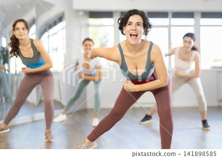 Funk jazz dancers practicing dance moves in studio Funk jazz dancers practicing dance moves in studio 141898585