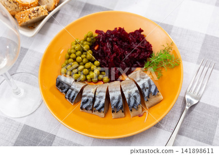 Cold smoked mackerel with beetroot and green peas 141898611