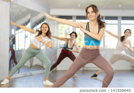 Young woman doing dabbing during street dance workout in studio Young woman doing dabbing during street dance workout in studio 141898648