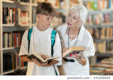 Grandmother and grandson choosing books in bookstore Grandmother and grandson choosing books in bookstore 141898668