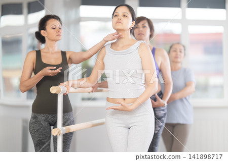 Choreographer coach teaches amateur students to keep their heads straight during ballet lesson Choreographer coach teaches amateur students to keep their heads straight during ballet lesson 141898717