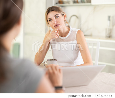 An insurance agent tells young girl the terms of property and life insurance An insurance agent tells young girl the terms of property and life insurance 141898873