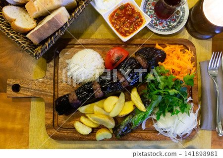 Turkish Patlicanli kebap from eggplant and beef meatballs with garnish 141898981