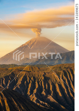 Scenery view of Mount Semeru volcano, Indonesia's highest and most active volcano on Java, frequently emits smoke, ash, and steam plumes. Scenery view of Mount Semeru volcano, Indonesia's highest and most active volcano on Java, frequently emits smoke, ash, and steam plumes. 141899673