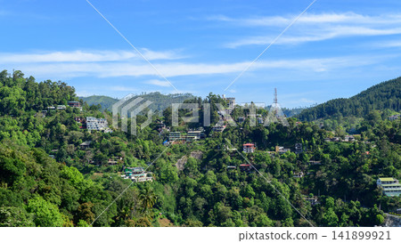 Hillside deforestation and urban development with houses and hotels expanding into forested mountains in Nuwara Eliya, Sri Lanka Hillside deforestation and urban development with houses and hotels expanding into forested mountains in Nuwara Eliya, Sri Lanka 141899921