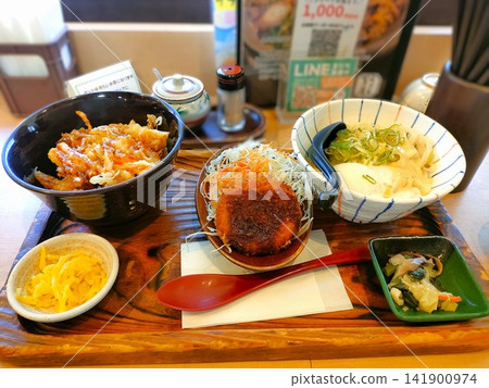 A hearty Japanese set meal featuring tempura rice bowl and udon noodles. A hearty Japanese set meal featuring tempura rice bowl and udon noodles. 141900974