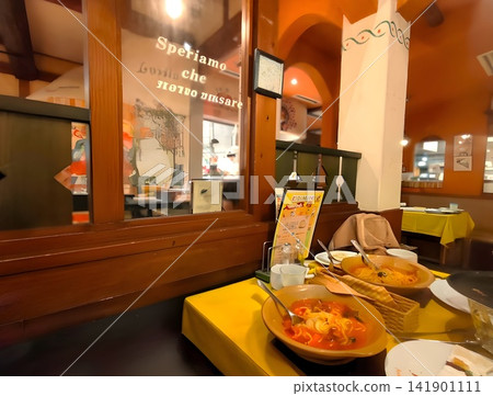 A meal at a warm and inviting Italian restaurant. A meal at a warm and inviting Italian restaurant. 141901111