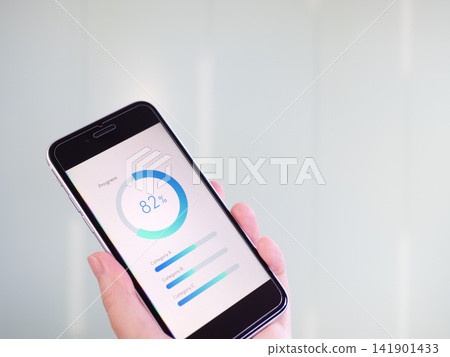 Business photos of progress graphs and analysis dashboards displayed on a smartphone (smartphone screen images are original creations). Business photos of progress graphs and analysis dashboards displayed on a smartphone (smartphone screen images are original creations). 141901433