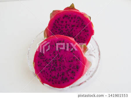 Cross-section of a dragon fruit | Vibrant reddish-purple flesh and black seeds Cross-section of a dragon fruit | Vibrant reddish-purple flesh and black seeds 141901553