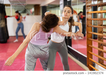 Women and girls in self-defense class Women and girls in self-defense class 141902374