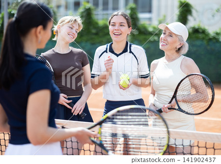 Tennis match female participants chat after game Tennis match female participants chat after game 141902437