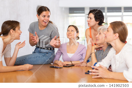 Female students learning course subject together in university classroom Female students learning course subject together in university classroom 141902503