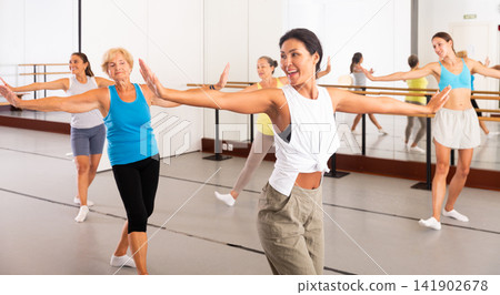 Modern active females dancing excited posing in studio Modern active females dancing excited posing in studio 141902678