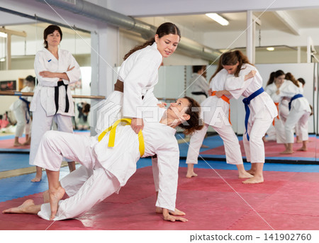 Women practice judo techniques in pairs Women practice judo techniques in pairs 141902760