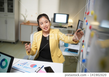 Businesswoman Planning Strategy on Office Whiteboard Businesswoman Planning Strategy on Office Whiteboard 141902820
