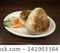 A Japanese-style plate featuring fragrant grilled rice balls and colorful pickles. 141903384