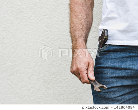 Attractive man, hand tools and work clothes Attractive man, hand tools and work clothes 141904094