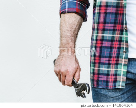 Attractive man, adjustable wrench and work clothes Attractive man, adjustable wrench and work clothes 141904104